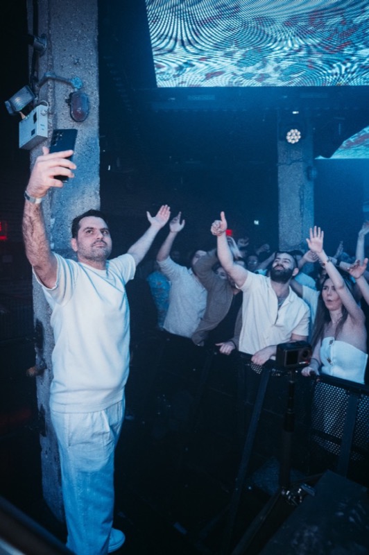 Iranian DJ in London behind professional decks — high-energy Persian party photography