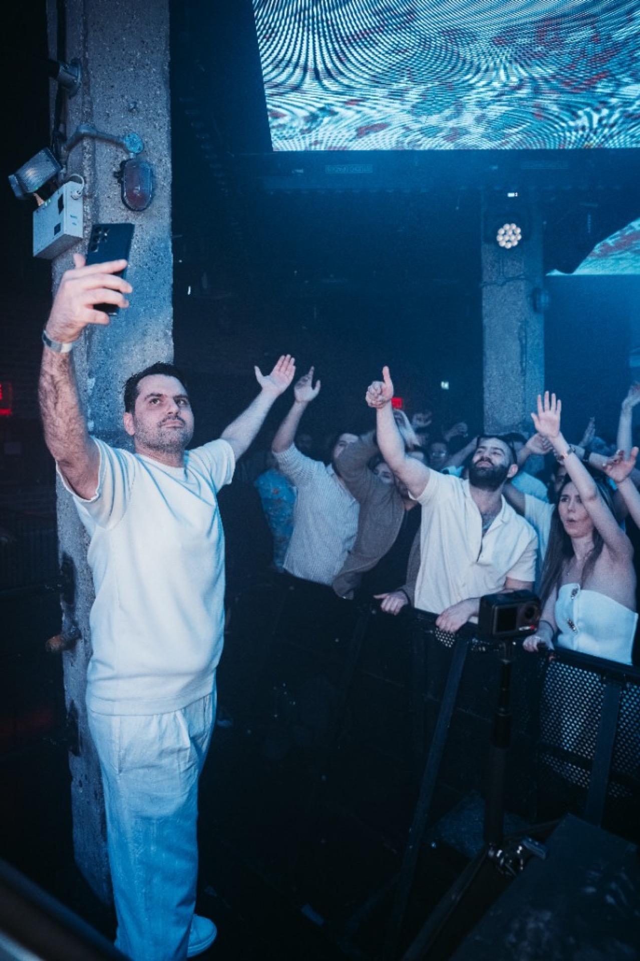 Iranian DJ in London behind professional decks — high-energy Persian party photography